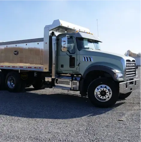 MAC Straight Trailer mounted to pale green semi truck. 
