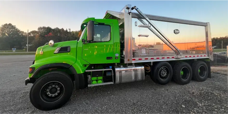 MAC Straight Trailer mounted to neon green semi truck. 